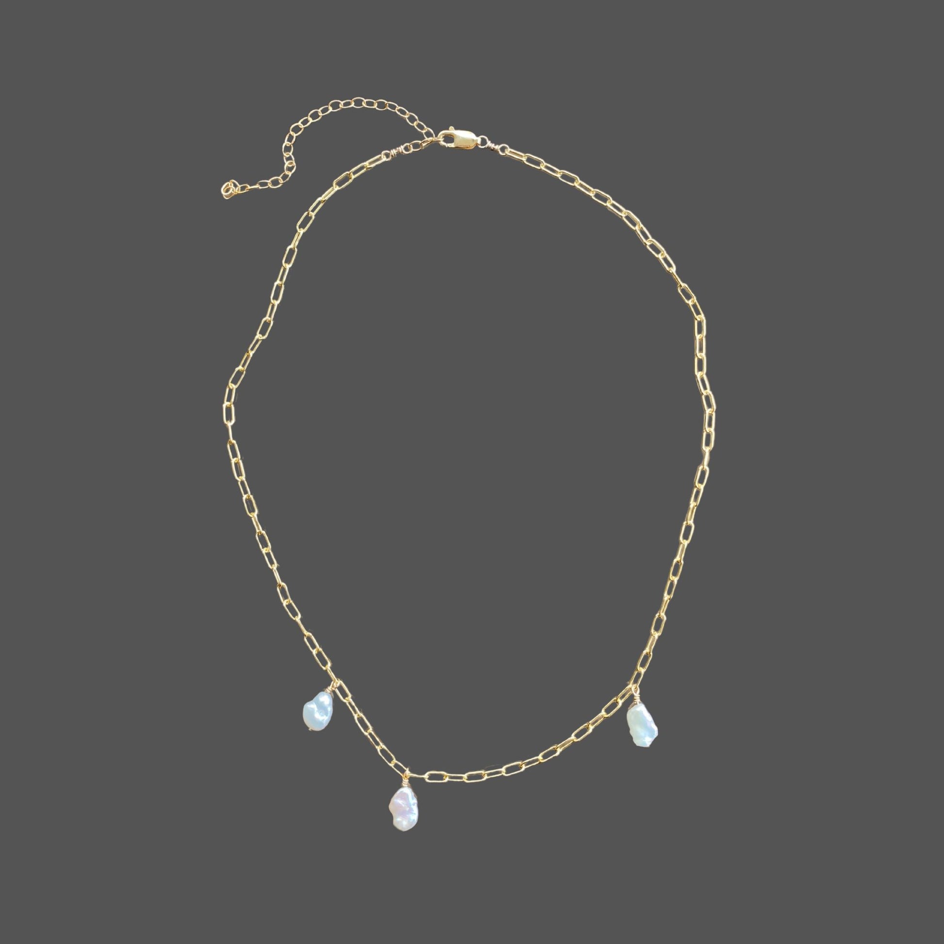 Pearl necklace on gold paperclip chain, with 3 asymmetrically placed baroque freshwater pearls.