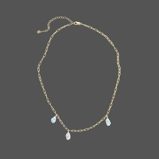 Pearl necklace on gold paperclip chain, with 3 asymmetrically placed baroque freshwater pearls.