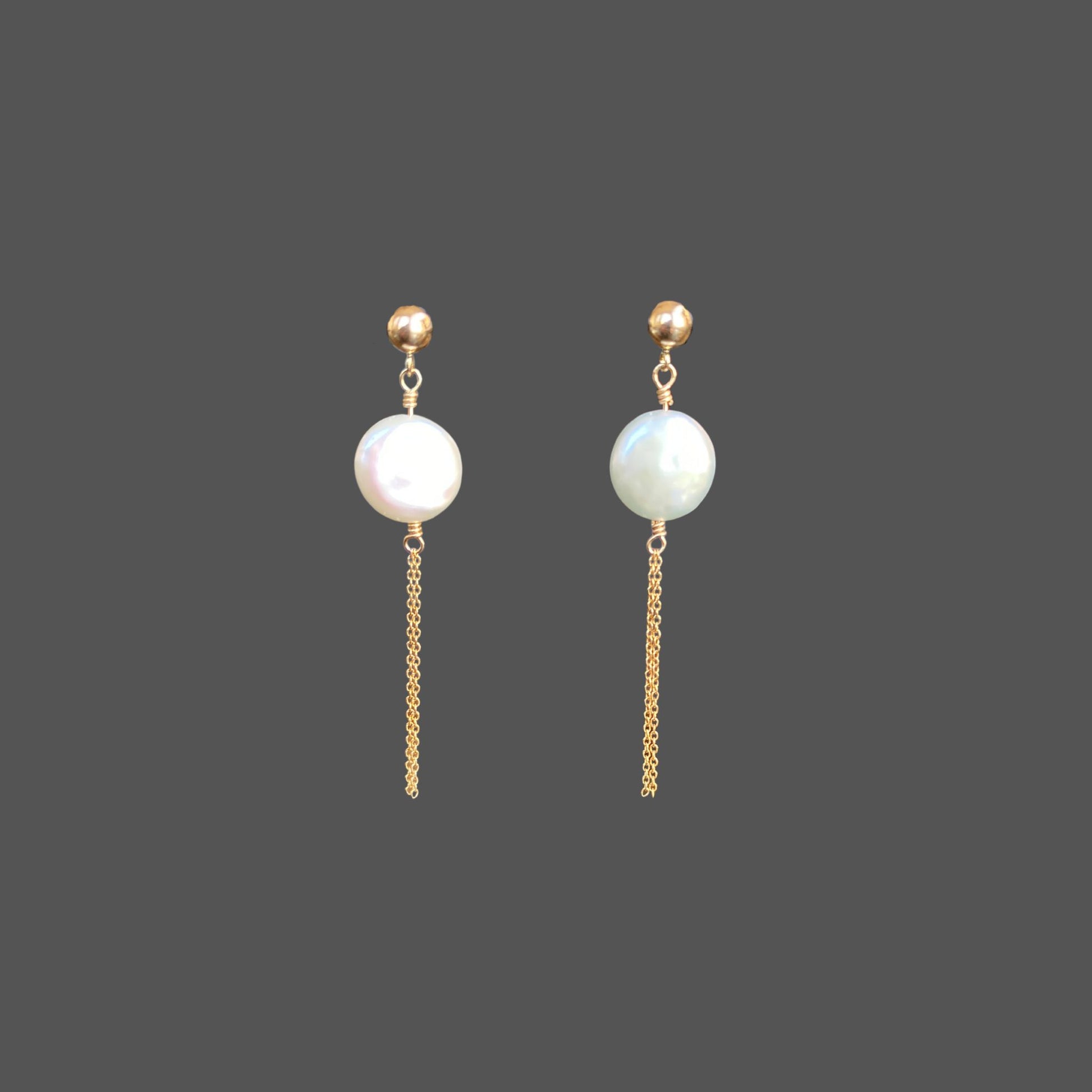 Front view of pearl earrings with a gold ball stud, featuring a round freshwater coin pearl and two strands of gold chain hanging below the pearl.