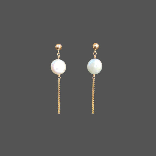Front view of pearl earrings with a gold ball stud, featuring a round freshwater coin pearl and two strands of gold chain hanging below the pearl.
