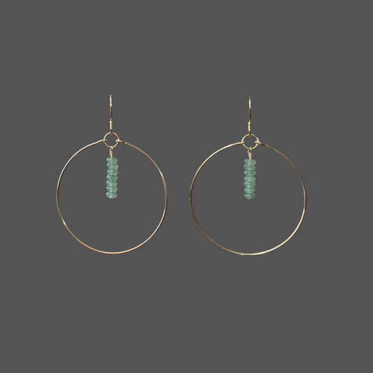 Gold hoop earrings with green aventurine beads hung from top center of hoop.