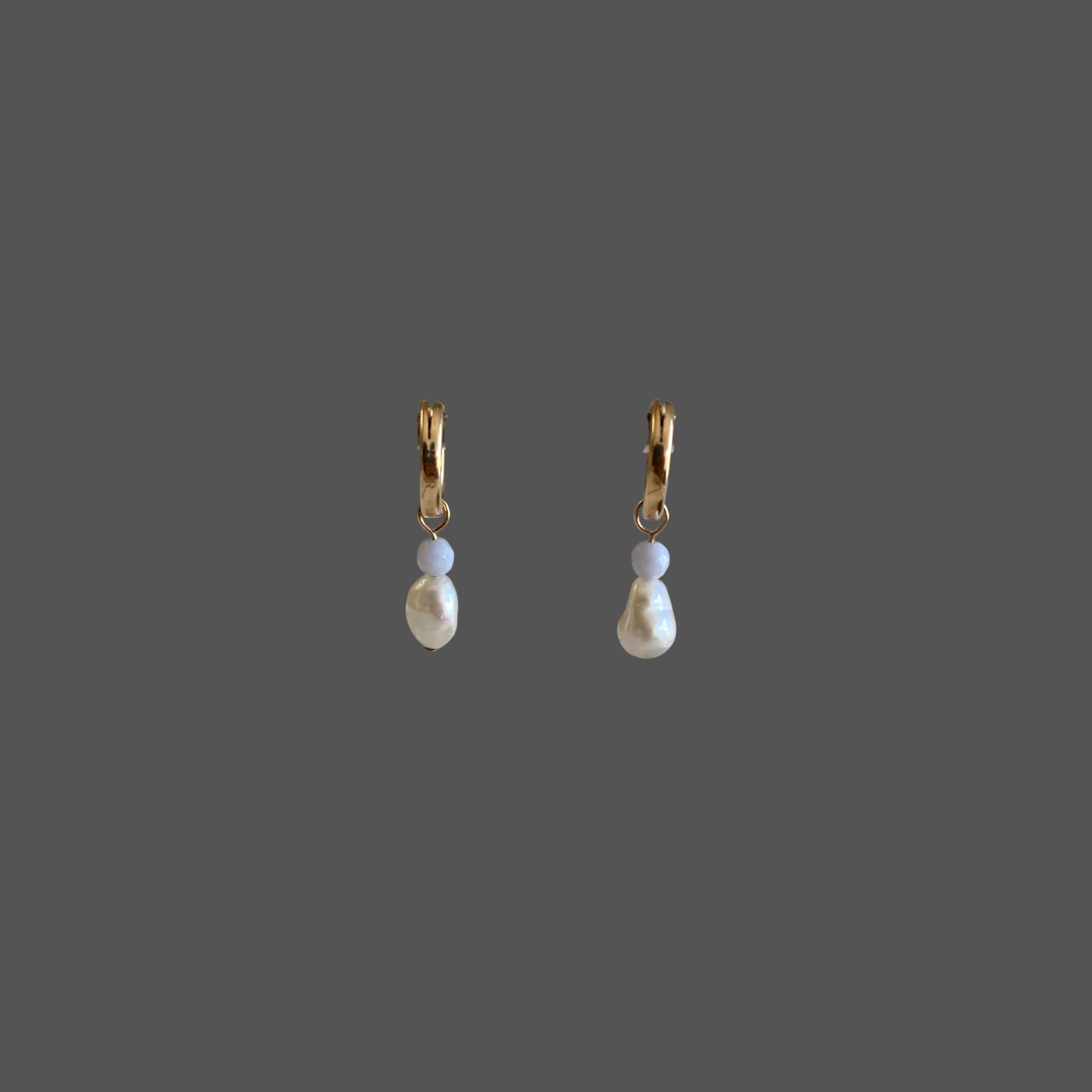 Front view of pearl earrings featuring gold hoops charms with blue lace agate gemstones and freshwater pearls.