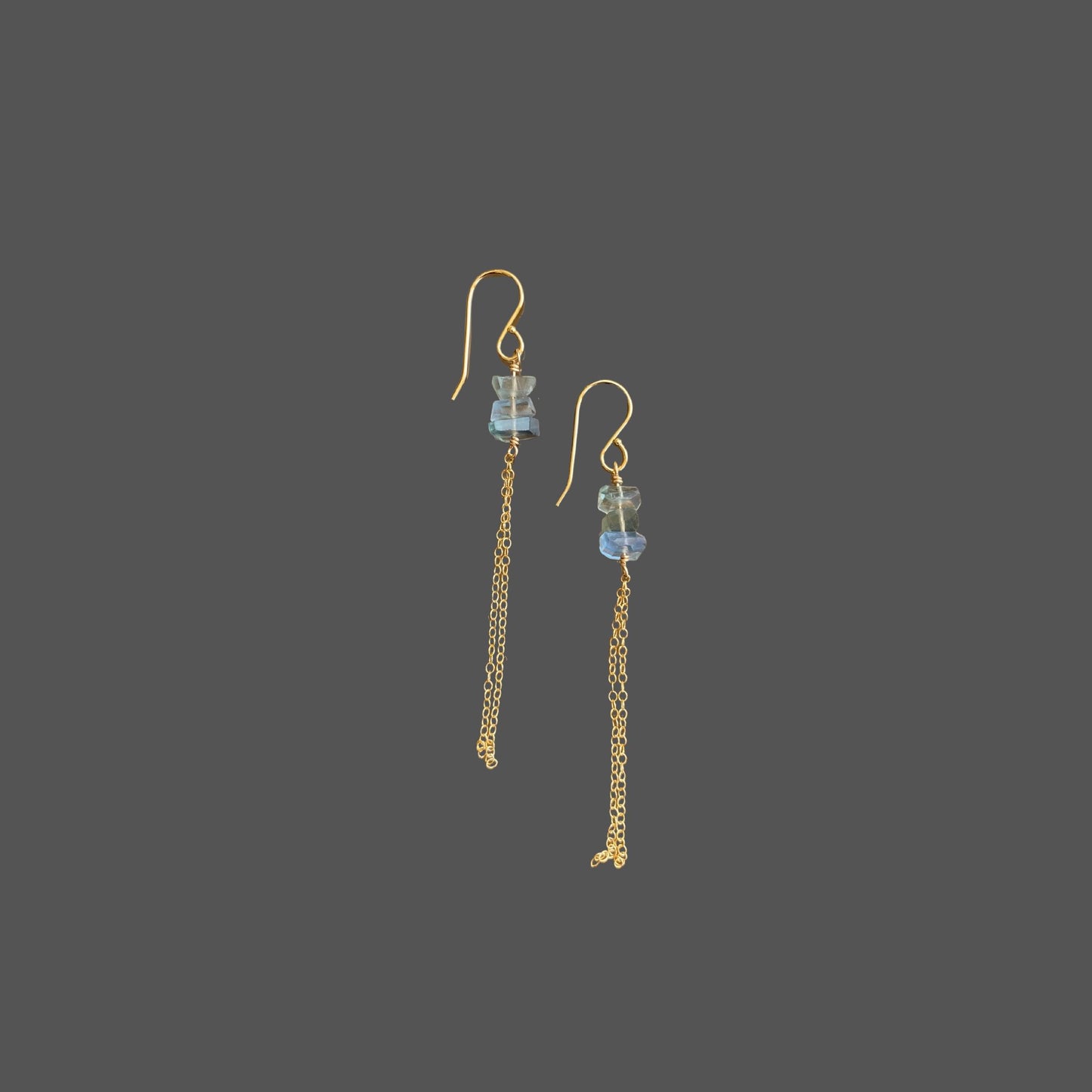 Side view of long earrings with French earwires, featuring three transparent blue-green fluorite gems and delicate gold chains hanging below.