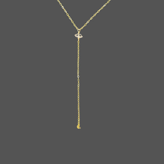 Close-up of herkimer diamond pendant and cascading chain on gold necklace. Shown alone on plain background.