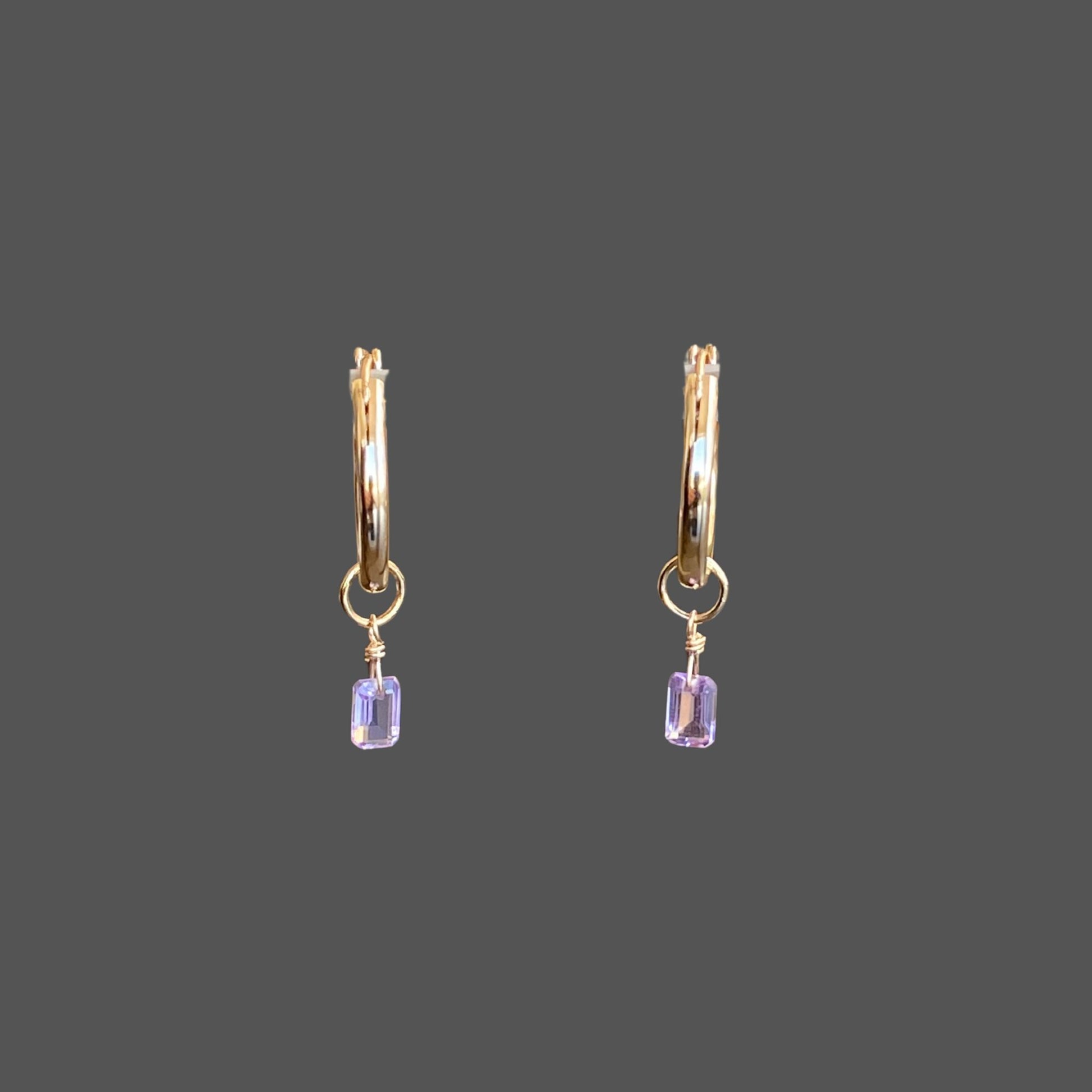 Gold hoop earrings with amethyst charms, featuring elegant octagon-cut stones. Minimal and elegant.