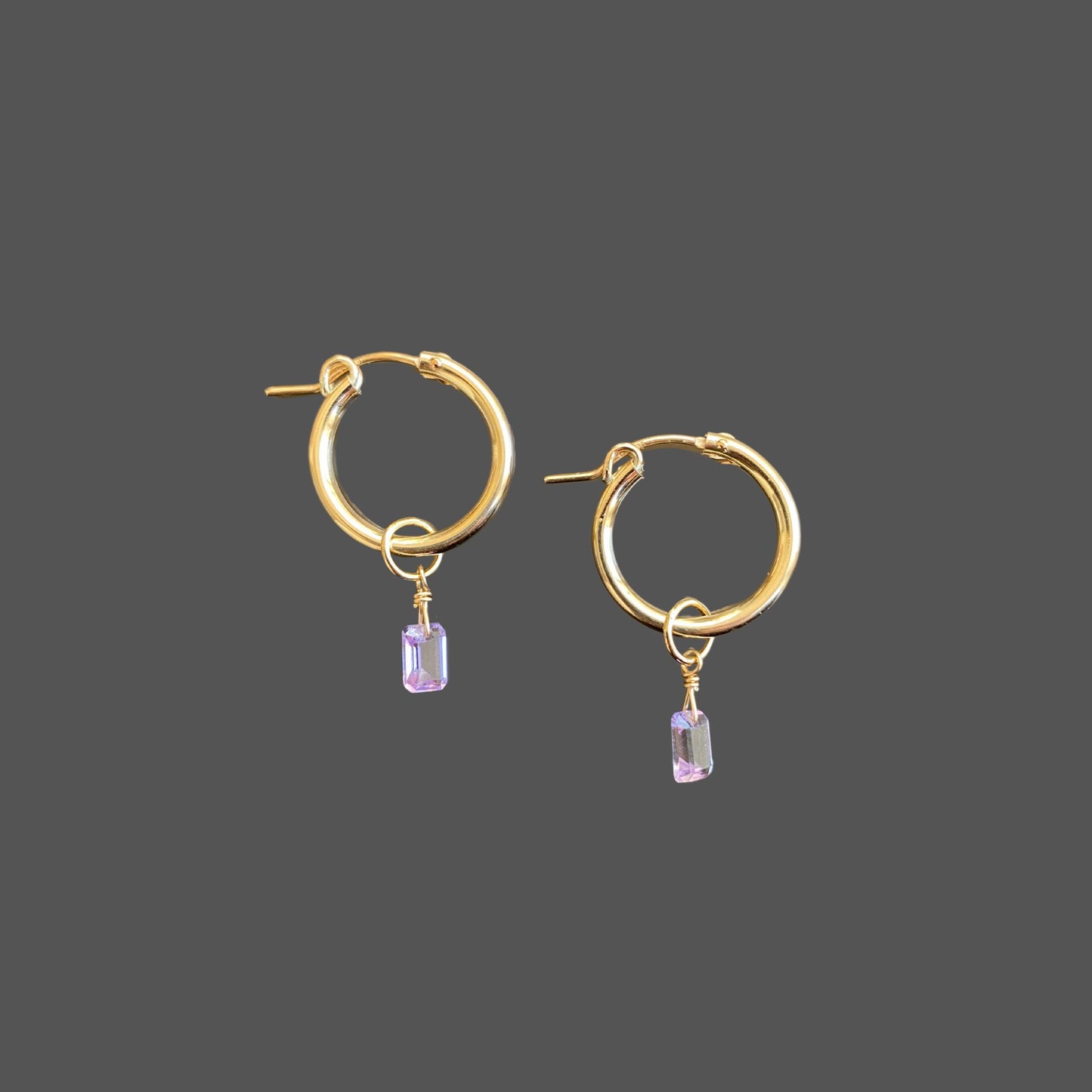 Gold hoop earrings with amethyst charms, featuring elegant octagon-cut stones. Minimal and elegant.