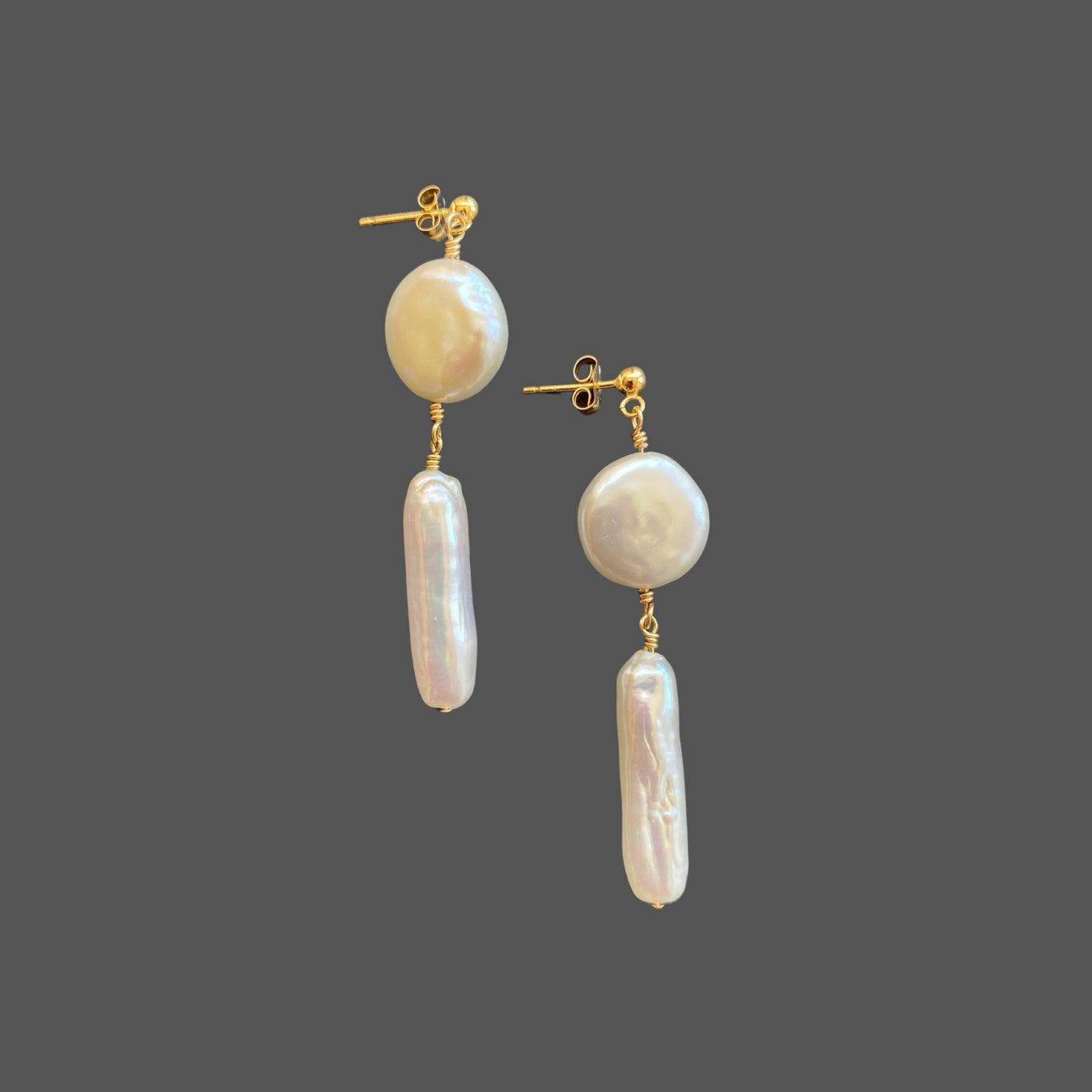 Side view of stud earrings with a gold ball stud and two freshwater pearls hanging below: a coin pearl with a stick pearl beneath it.