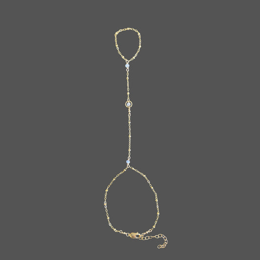 Gold-filled moonstone hand chain with a delicate beaded chain and three moonstone gems across the top of the hand.