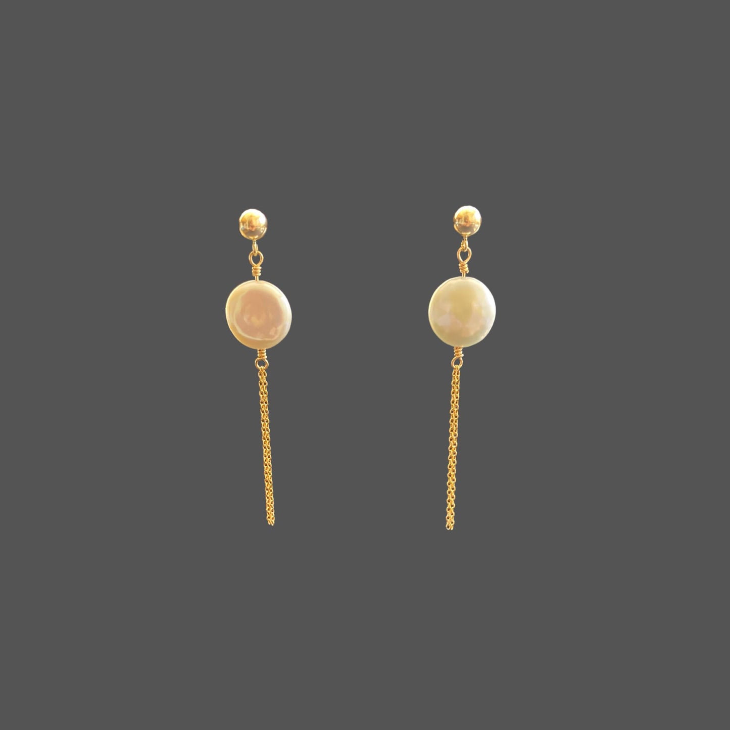 Front view of pearl earrings with a gold ball stud, featuring a round freshwater coin pearl and two strands of gold chain hanging below the pearl.