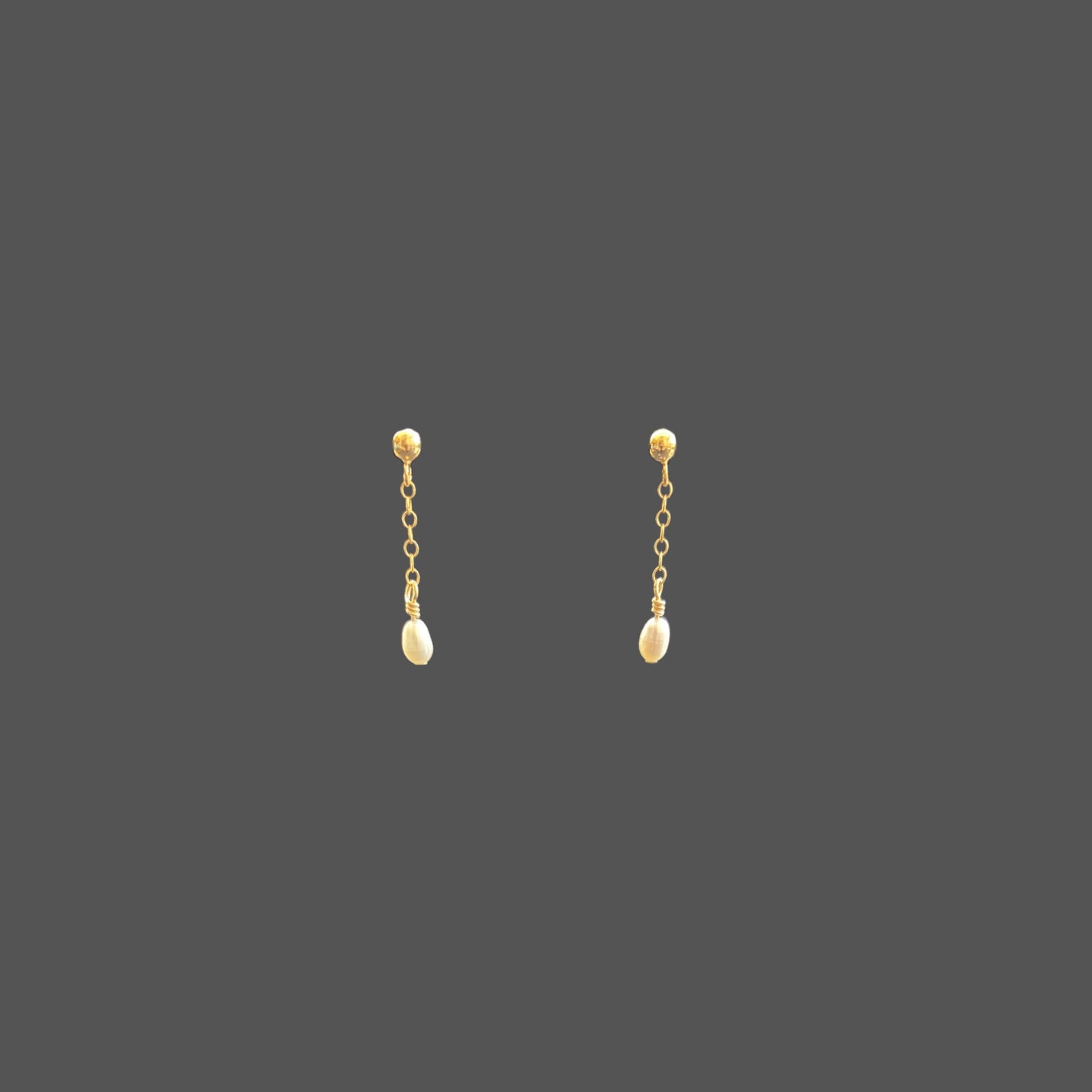 Front view of pearl earrings with a gold ball stud, featuring a short gold chain segment with a small rice pearl at the bottom.