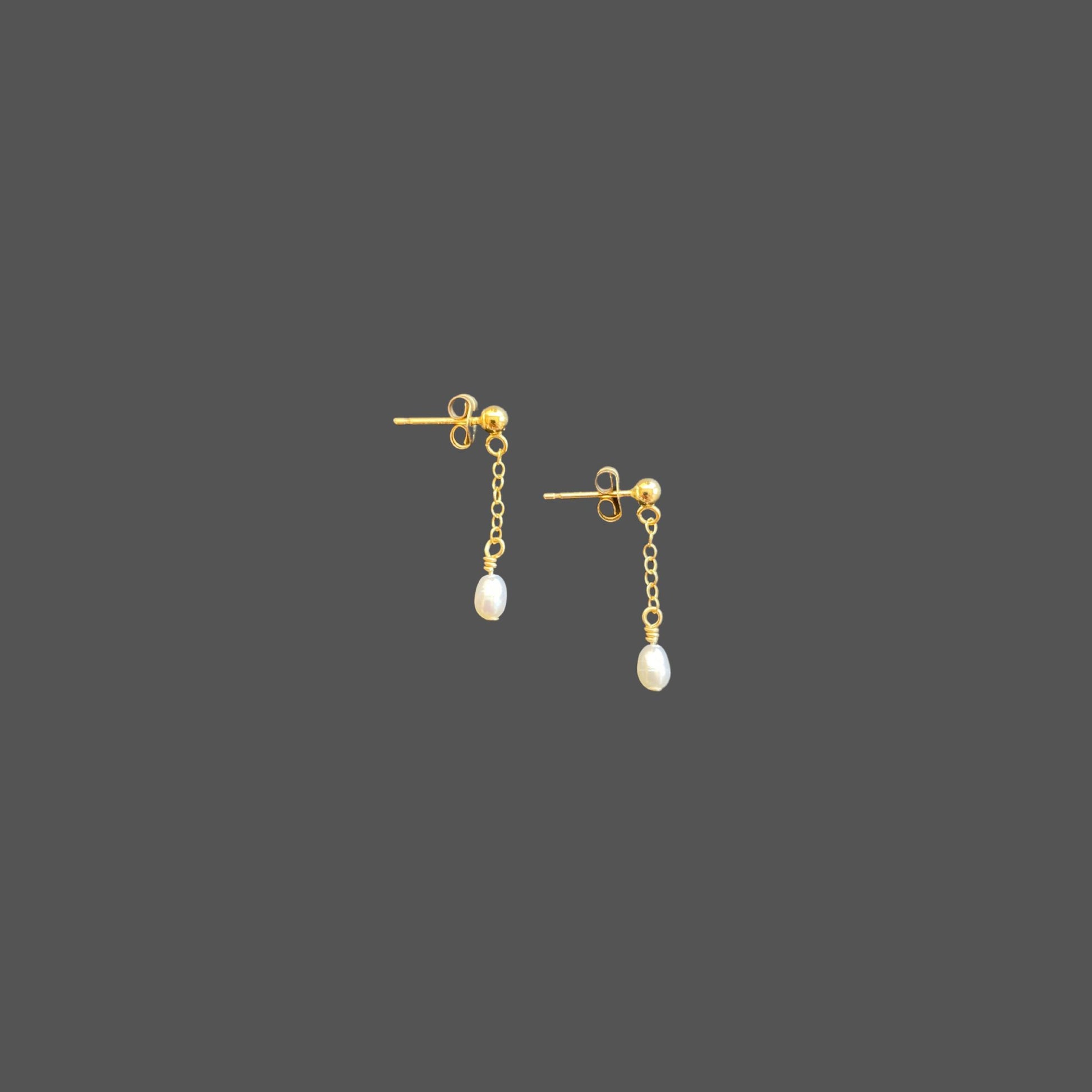 Side view of stud earrings with a gold ball stud, featuring a short gold chain segment with a small rice pearl at the bottom.