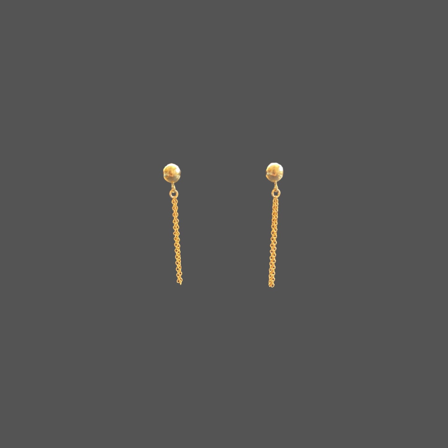 Front view of stud earrings with a gold ball stud and two strands of gold chain hanging below the ball.